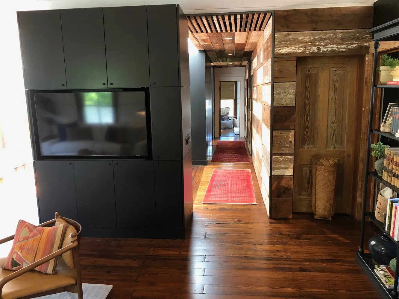 Custom media wall and reclaimed wood in a remodeled Houston home