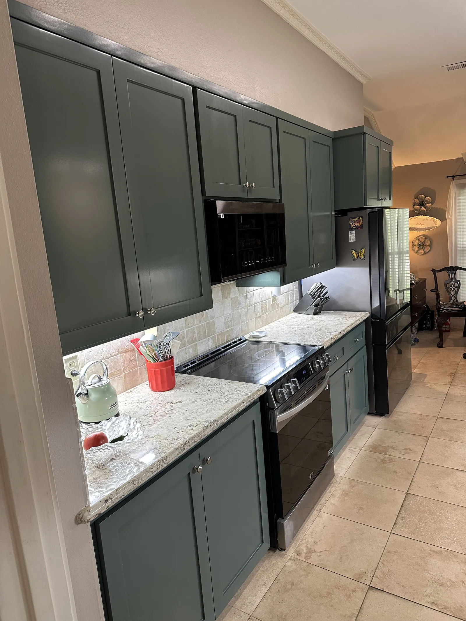 Green cabinet galley kitchen after remodel