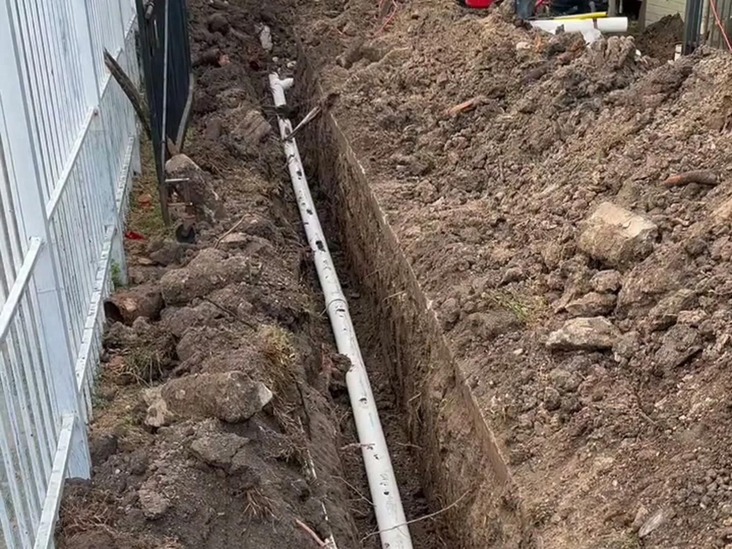 New sewer line set at grade in an open trench in Houston